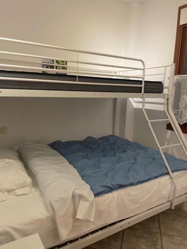 a bunk bed with a blue blanket on it at Casa Zebole in Calpe