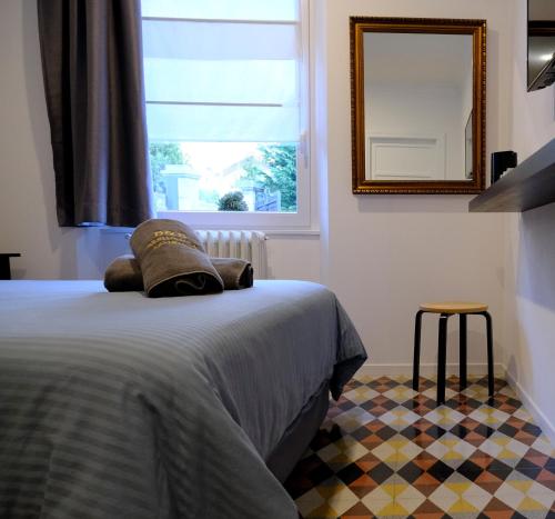 a bedroom with a bed with a mirror and a window at Residenza Laurum in Mandello del Lario