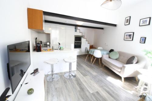 a living room with a couch and a table at Downtown Villa in Faro
