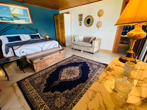 a bedroom with a bed and a table with a rug at Villa Incanto on the Sea in Siracusa