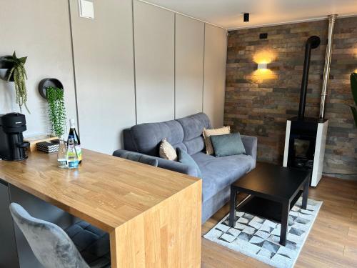 a living room with a couch and a table at The kube by the mountain in Timisul de Jos