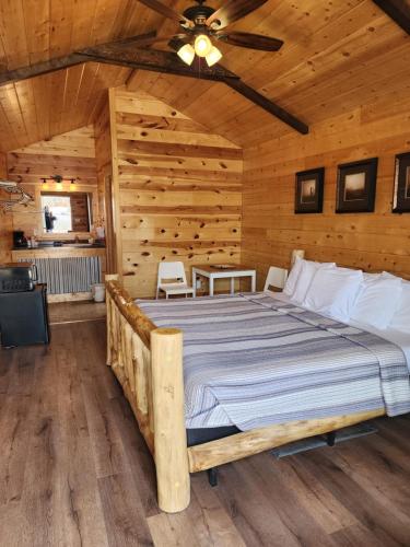 a bedroom with a bed in a log cabin at Bryce Valley Lodging in Tropic