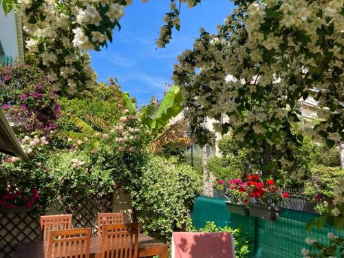 a garden of flowers and plants on a fence at Provencal house, sea side, private parking in Nice