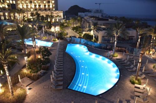 an overhead view of a swimming pool at night at Two Bedrooms Apartment at Address Residence Fujairah in Sharm