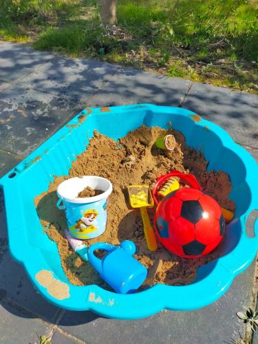 a sand pit with a soccer ball and a ball in it at BJ Chalets - Robbengat 85 - Gezellige chalet op vakantiepark Lauwersoog! Vroege incheck! MET AIRCO! in Lauwersoog