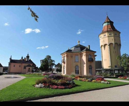 a building with a clock tower in a park at Stadt Villa Rastatt in Rastatt