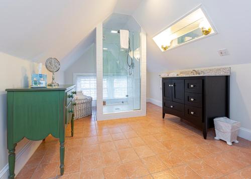 a bathroom with a green dresser and a mirror at Bass Cottage & Ullikana in Bar Harbor