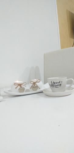 a pair of shoes and a cup on a table at Apartman Marina Aranđelovac in Arandjelovac