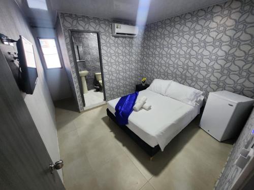 Una cama o camas en una habitación de HOTEL COSTA AZUL SAI