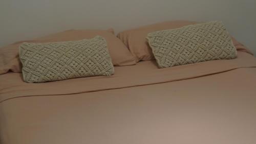 a bed with two pillows on top of it at Departamento en Palermo in Buenos Aires