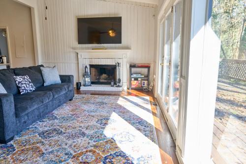 a living room with a couch and a fireplace at Bright & Comfy 5 star Location Large Deck Oasis in Atlanta