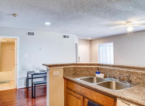 a kitchen with a sink and a counter top at Lovely 2 bedroom, 1 bath condo with pools and gym. in Houston