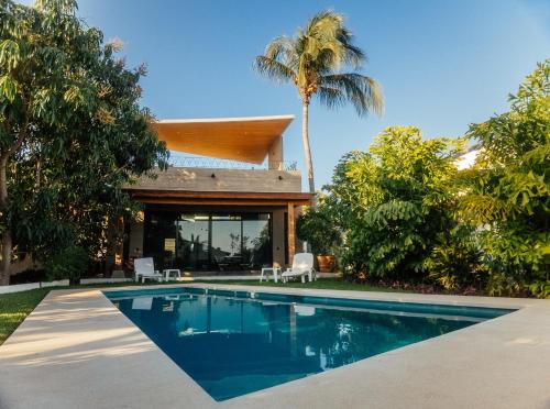 a house with a swimming pool in the yard at Casa Pelicano in Puerto Escondido