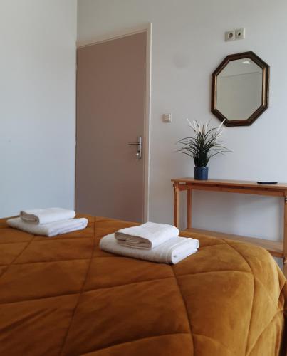 a bedroom with a bed with towels on it at DREAM & HARMONY in Artemida