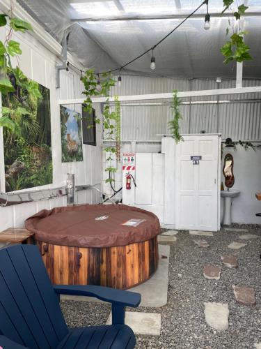 a room with a round table and a blue chair at Casita Don Eliber in Fortuna