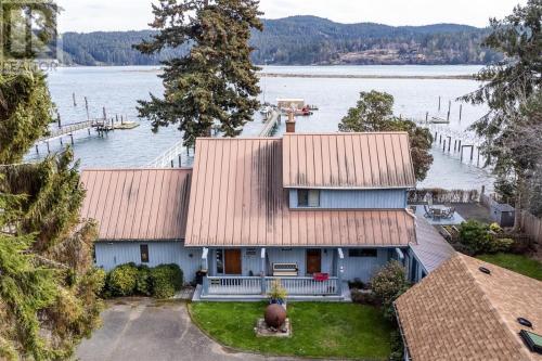 an aerial view of a house on the water at Salty Towers Ocean Front Cottages in Sooke