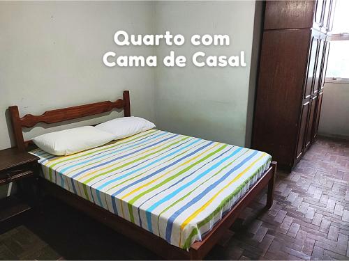 Bett mit gestreifter Matratze in einem Zimmer in der Unterkunft Apartamento em Vitória capital do ES in Vitória