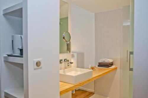 a bathroom with a sink and a mirror at Hotel Restaurant Santiago in Hendaye
