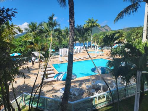a view of the pool from the resort at Apart Hotel Alecrim Praia de Camboinhas com Marina pe na areia in Niterói