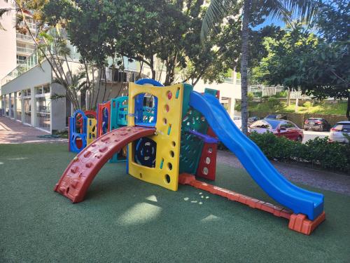 a playground with a slide in a park at Apart Hotel Alecrim Praia de Camboinhas com Marina pe na areia in Niterói