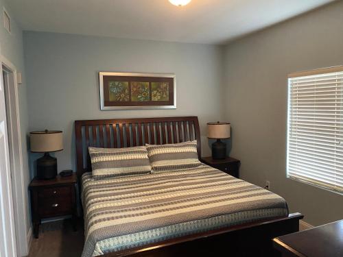 a bedroom with a bed with two night stands and two lamps at Laketown Wharf 1717 in Panama City Beach