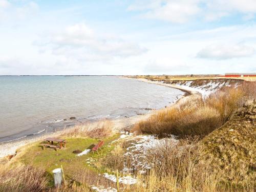 a view of a beach with the ocean and a train at Modern Cottage with Spa - By Traum Ferienwohnungen in Vinderup