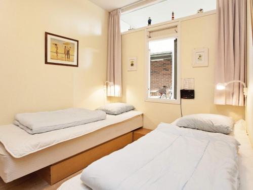 a hospital room with two beds and a window at 4 person holiday home on a holiday park in Fanø in Fanø