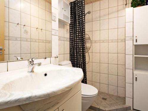 a bathroom with a sink and a toilet at 4 person holiday home on a holiday park in Fanø in Fanø