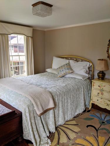 a bedroom with a bed with pillows and a window at Waterfront Getaway in Wethersfield
