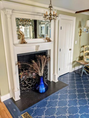 a fireplace in a living room with a blue vase at Waterfront Getaway in Wethersfield