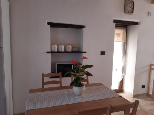 a dining room with a table and a fireplace at Casa Ylenia in Borzonasca