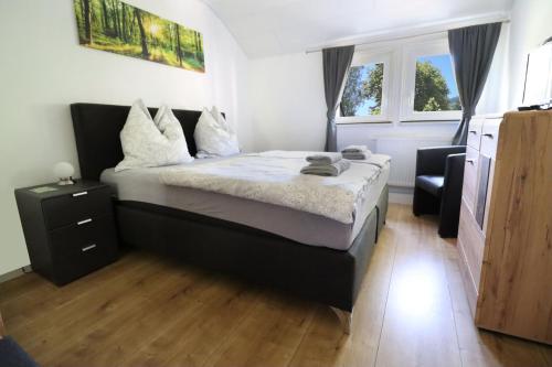 a bedroom with a bed and a window at Am Klosterviertel in Bad Herrenalb
