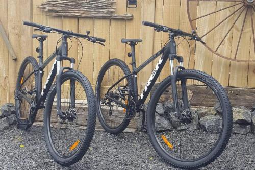two bikes parked next to a wooden fence at Crown Ridge Miners Cottage in Karangahake