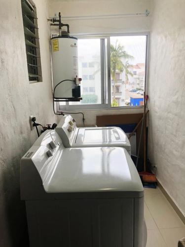 two white sinks in a room with a window at hermoso condominio suites las palmas con alberca in Manzanillo