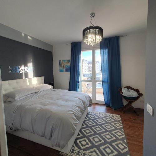 a bedroom with a large bed and a chandelier at Giancasavacanze in Alghero