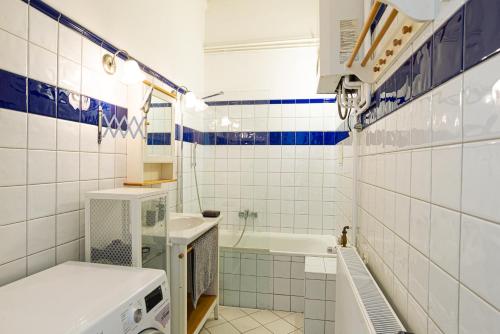 a small bathroom with a sink and a tub at Terrace VuVu - Apartment with balcony in the heart of Budapest in Budapest