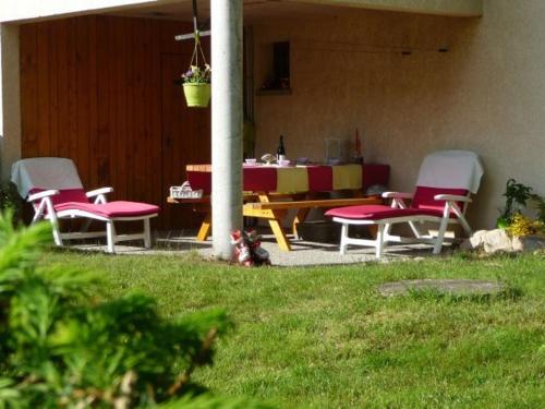 a group of chairs and a table in a yard at Chalet spacieux à Rochesson, près de Gérardmer, avec garage, cheminée, WIFI et équipements complets - FR-1-589-167 in Rochesson