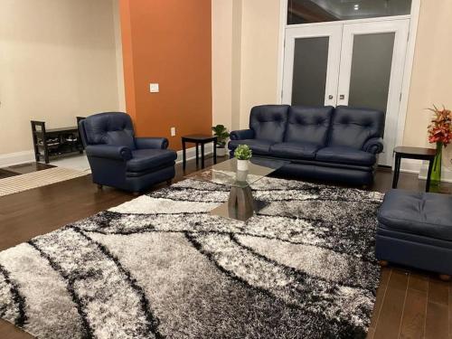 a living room with couches and a rug at Dazzling Modern Home Next to Beach & Go in Pickering