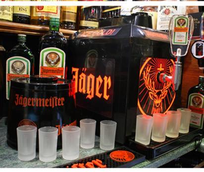 a group of cups on a counter with bottles of alcohol at Clifton Court Hotel in Blackpool
