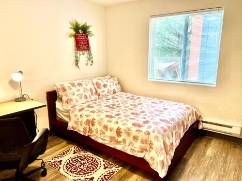 a bedroom with a bed and a desk and a window at Apartment in University District- Micro Studio in Seattle