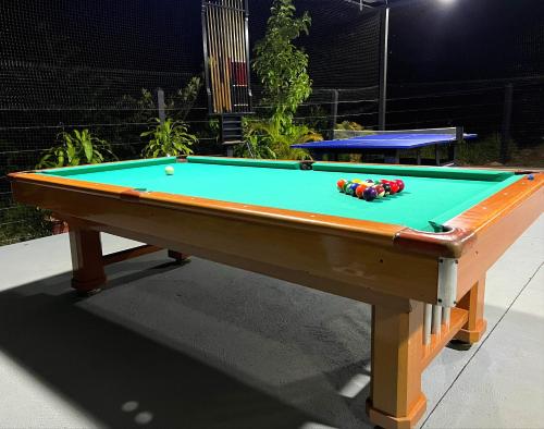 a pool table with a green cloth on it at Hotel Capri Doradal in Doradal