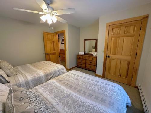 a bedroom with two beds and a ceiling fan at NEW Single family home with spectacular views and lots of space Privacy convenience and style in Carroll