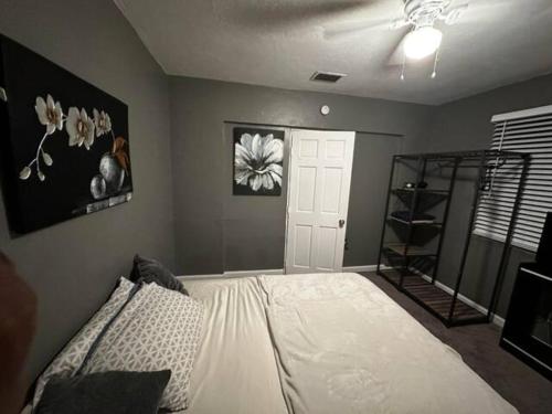 a bedroom with a large white bed and a shelf at Private Residence - Universal Studio in Orlando
