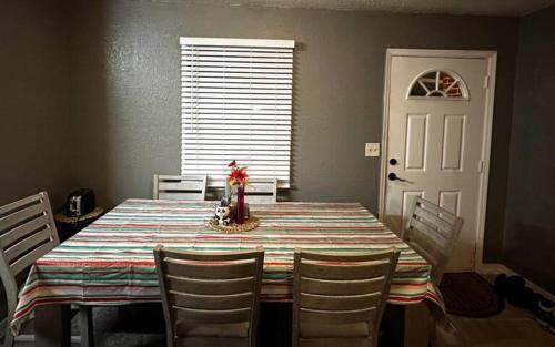 a dining room with a table and chairs and a white door at Private Residence - Universal Studio in Orlando