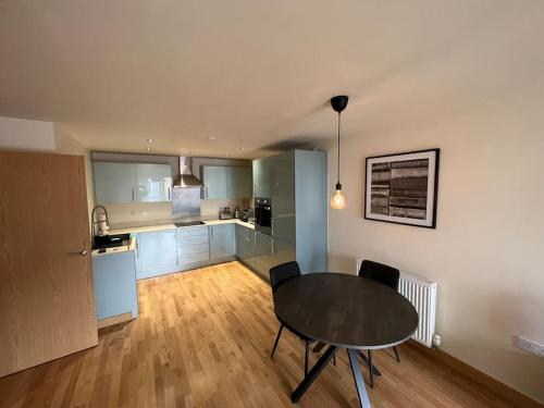 a kitchen and dining room with a table in a room at Stunning Cozy Flat. in Kent