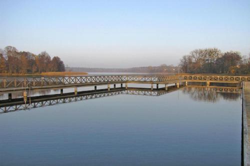 a bridge over a large body of water at Apartment right on the lake Ryn in Ryn