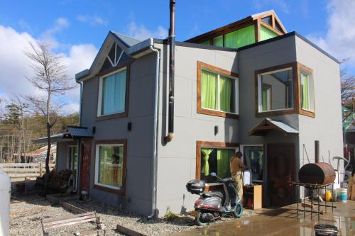 a house being constructed with a scooter parked in front at Caballo de Fuego in Ushuaia