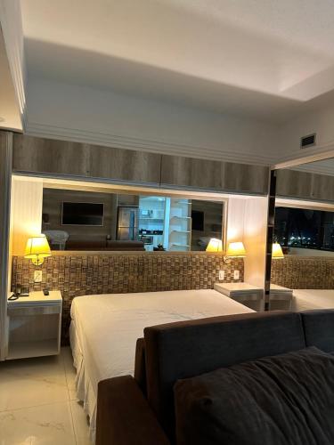 a bedroom with a bed and a couch at Tropical Executive Hotel N 619 in Manaus