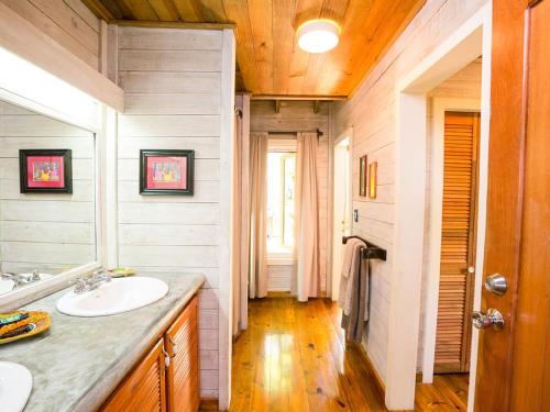 a bathroom with a sink and a mirror at Purple Palace in Sandy Bay