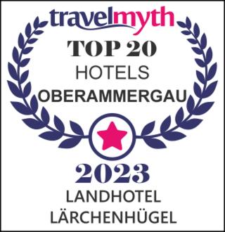 a sign with a laurel wreath and a star at Landhotel Lärchenhügel in Oberammergau